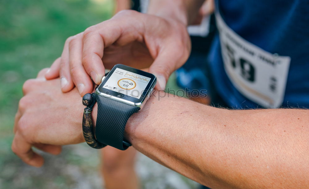 Sportsman looking a smartwatch