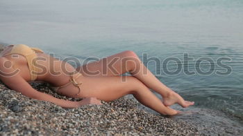 Similar – Image, Stock Photo Portrait of a young blonde woman in a bikini, sitting in the Baltic Sea surf