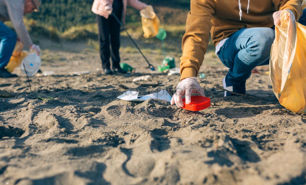 Similar – Young man cleaning the beach