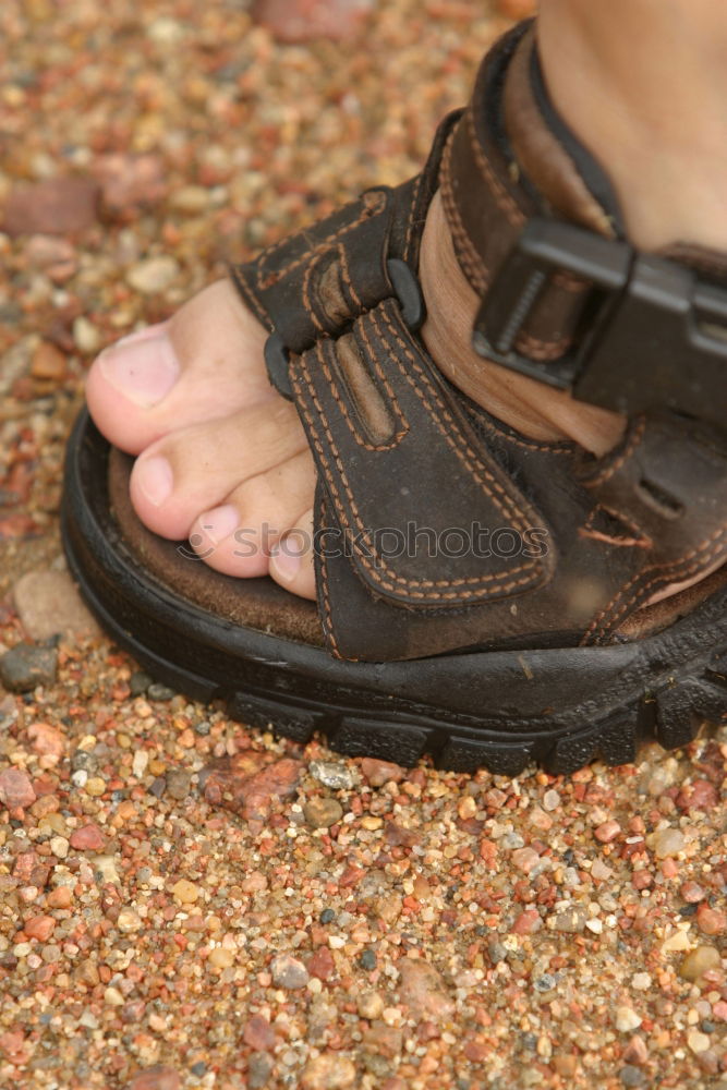 Similar – Dirty muddy bare feet with a pair of water boots on a muddy path