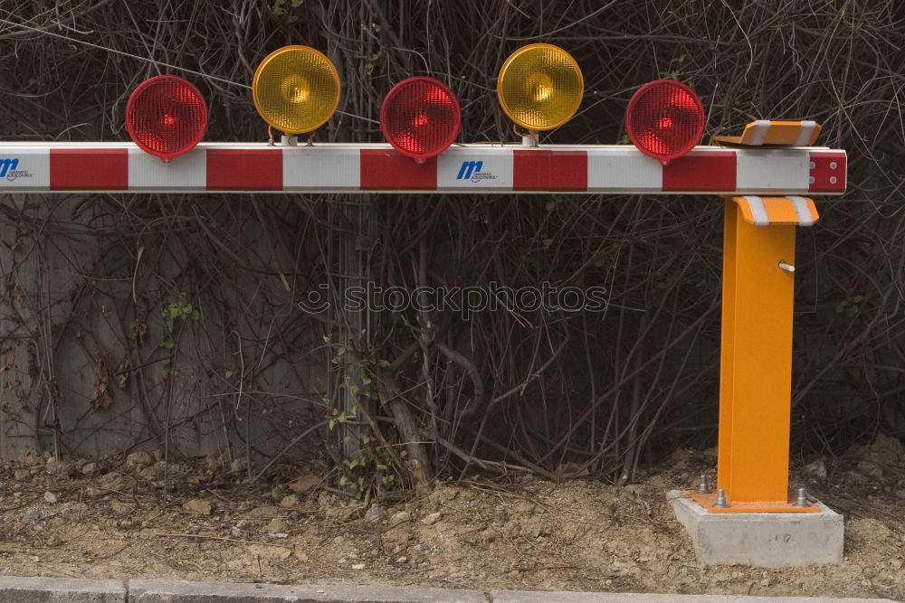 Similar – red sprayed warning sign about clearance height on barge in front of construction fence and bushes.