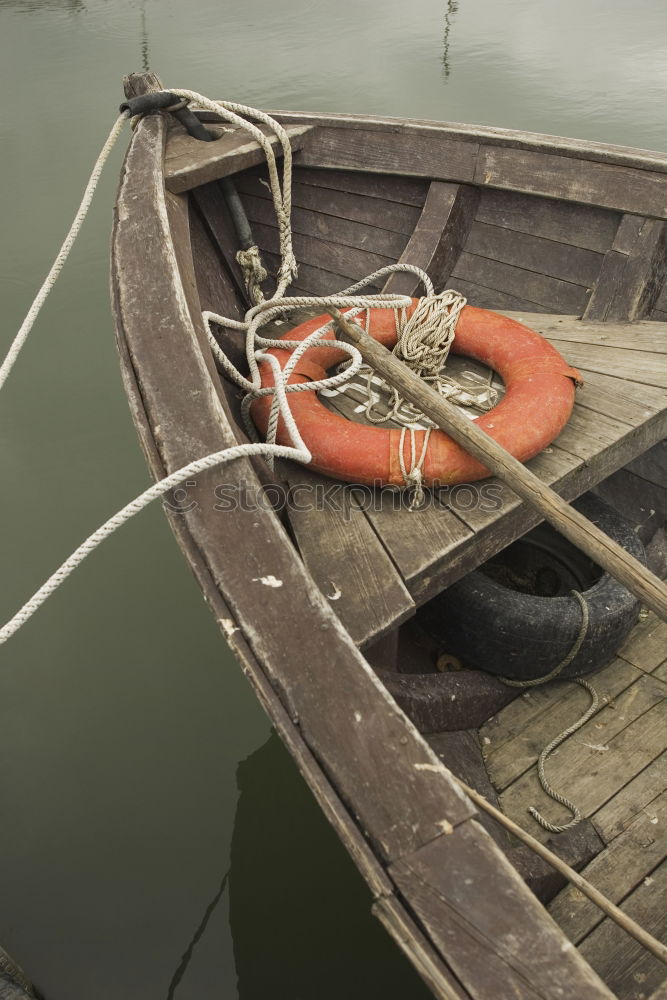 Similar – Spiegelung der Unterseite eines Fischerbootes im Abendlicht