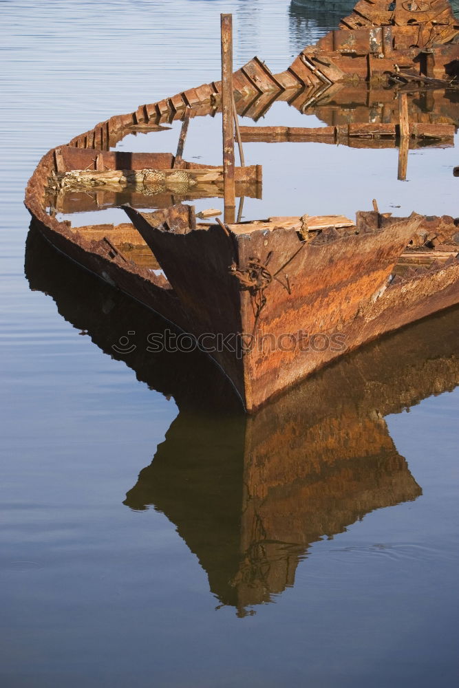 Similar – Spiegelung der Unterseite eines Fischerbootes im Abendlicht