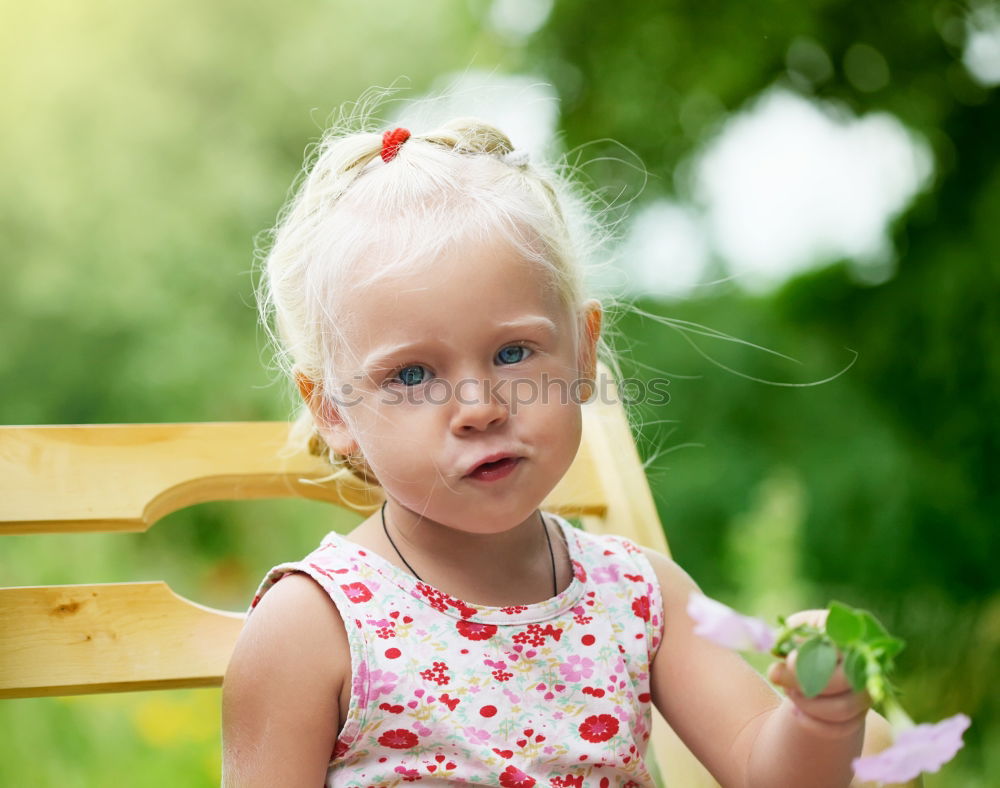 Similar – Image, Stock Photo Small baby playing with toy sitting on the ground in the park and looking to the camera