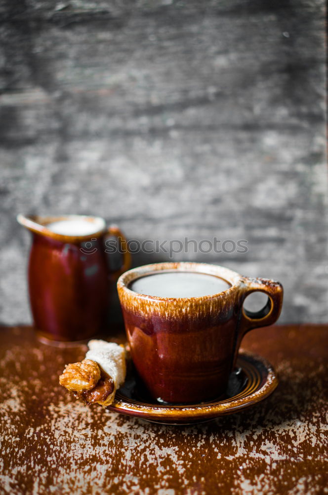 Similar – Cup of coffee on old wooden table with kitchen towel