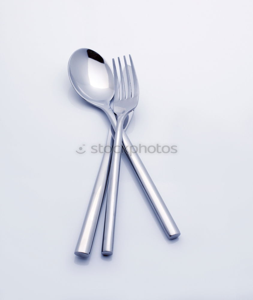 Similar – Disposable plastic cutlery on blue background. Top view