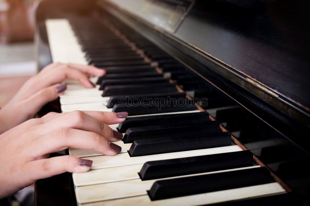 Similar – Toddler plays piano with delicate hands