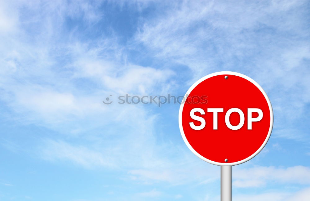 Signs I Traffic sign stop and prescribed driving direction to the right in front of a blue sky with clouds from the frog perspective / VZ 206 and VZ 209-20