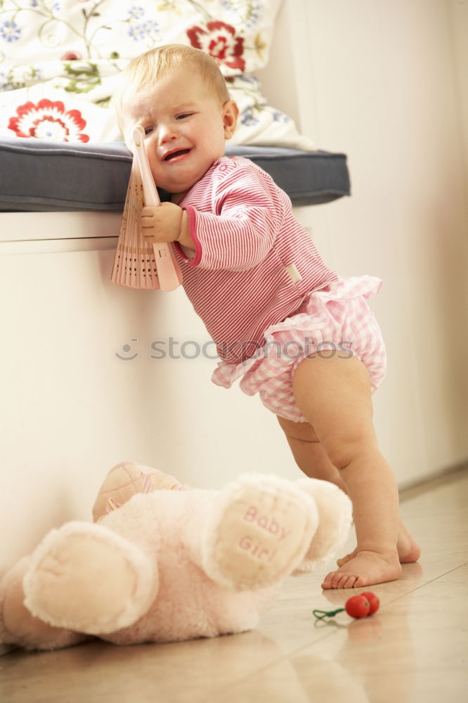 Similar – cute toddler girl put on socks at home