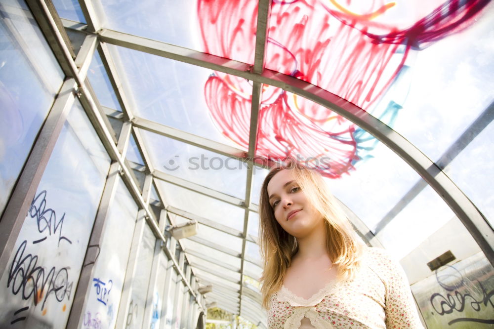 Similar – Image, Stock Photo Smiling woman in yellow dress standing and chatting on her smart phone in front of graffiti painted on corrugated iron