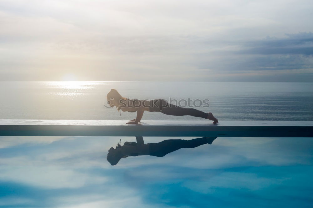 Athletic man balancing on gymnastic rings