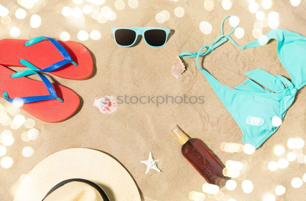 Similar – Draufsicht auf eine Strandtasche mit Flip Flops, Strandtuch, Sonnenbrille, Muscheln und Seesternen