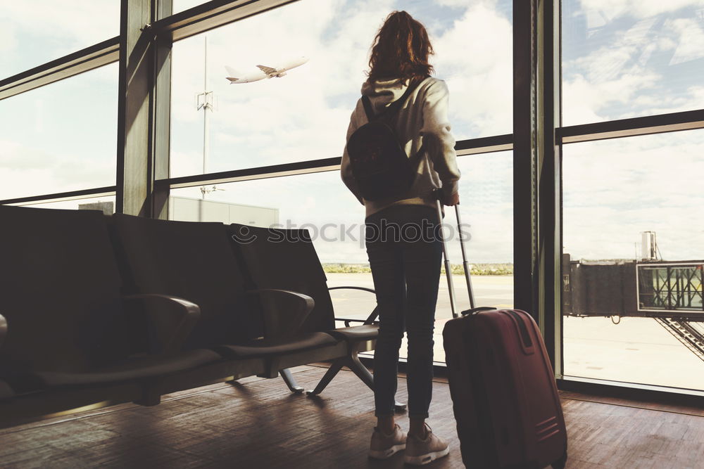 Similar – Image, Stock Photo Back of a young business man standing with the suitcase at the airport waiting for the flight
