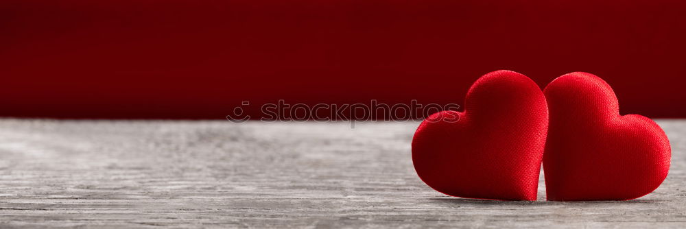 Similar – A yellow playing piece stands in the middle of many red lying playing pieces on a blue background