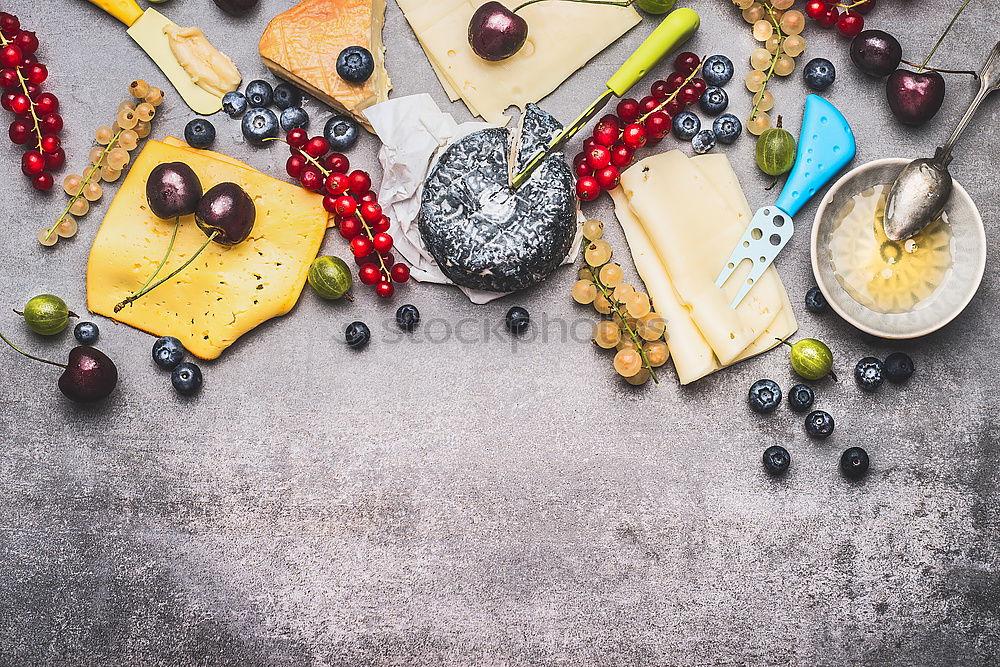 Delicious cheese platter with berries and honey