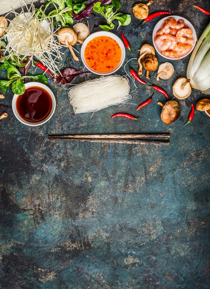 Asian cooking ingredients and sauces with chopsticks