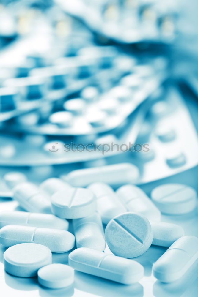 Similar – pill bottle,blister with white tablets,painkillers and a glass of water.Concept of medicine