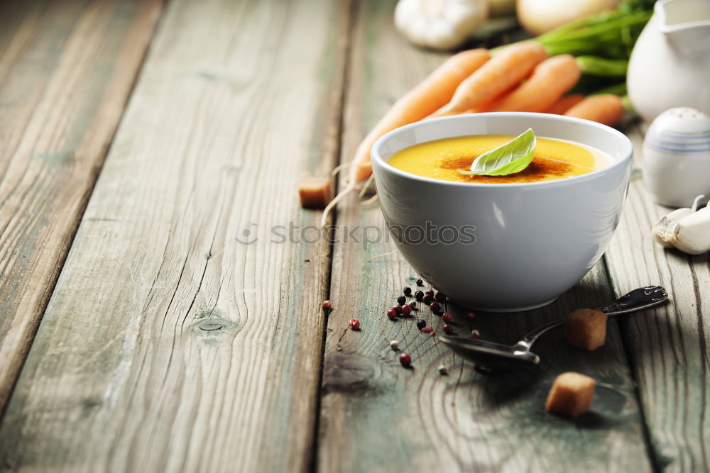 Similar – female hands holding an iron mug with carrot juice