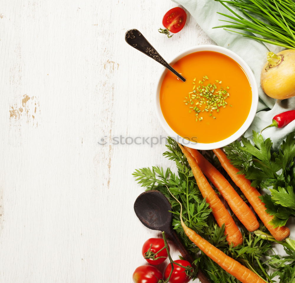 Similar – cup of carrot juice in female hands on a gray wooden surface