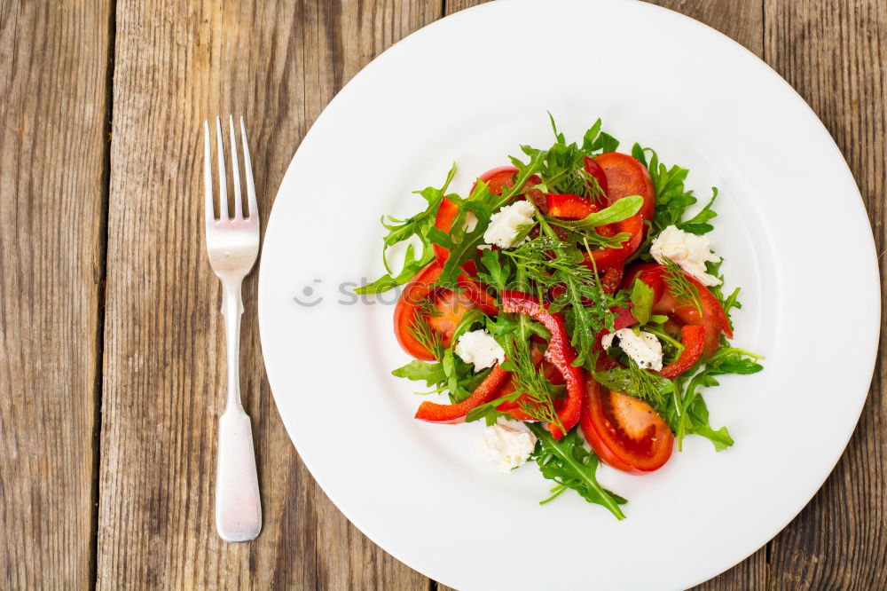 fresh salad on dark wooden table