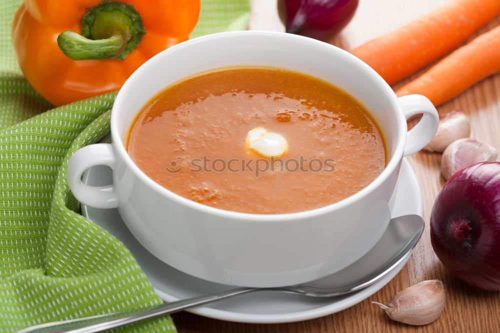 Iron mug with carrot juice in female hands