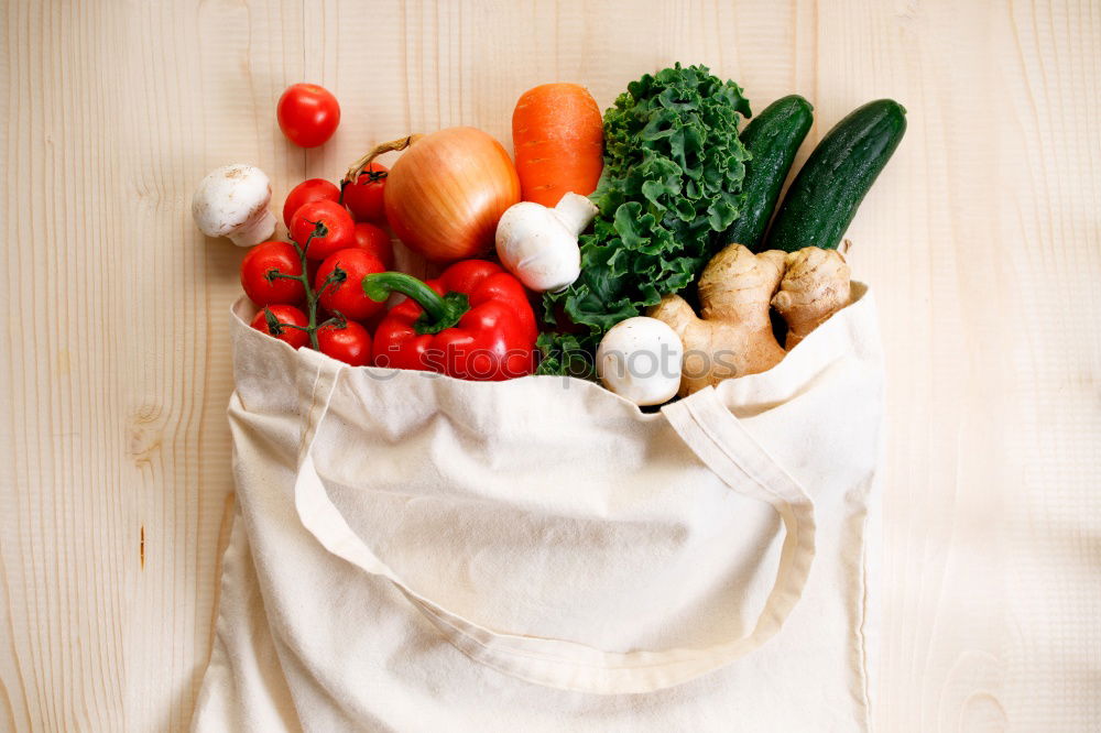 Image, Stock Photo Cloth bag with vegetables on wooden background.