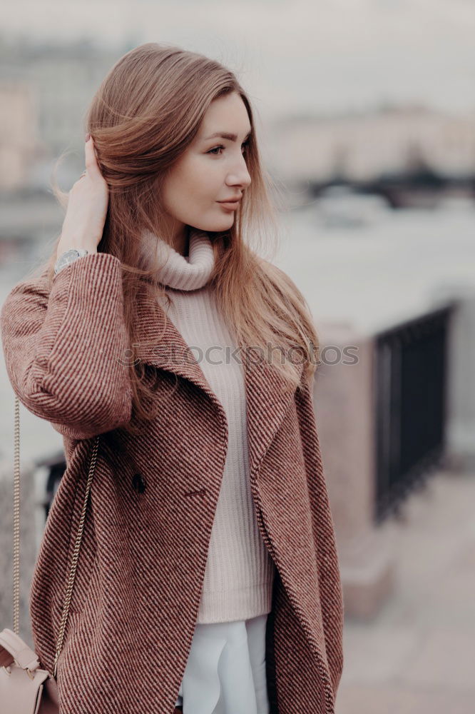 Thoughtful woman at lamp post