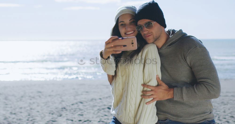 Similar – Image, Stock Photo Couple taking selfie photo in smartphone with sea and dark cloudy sky on background