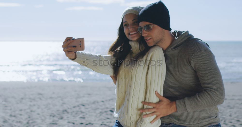 Image, Stock Photo Couple taking selfie photo in smartphone with sea and dark cloudy sky on background