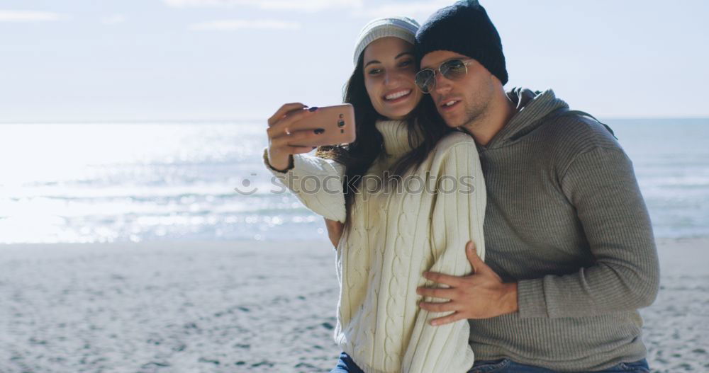 Similar – Image, Stock Photo Couple taking selfie photo in smartphone with sea and dark cloudy sky on background