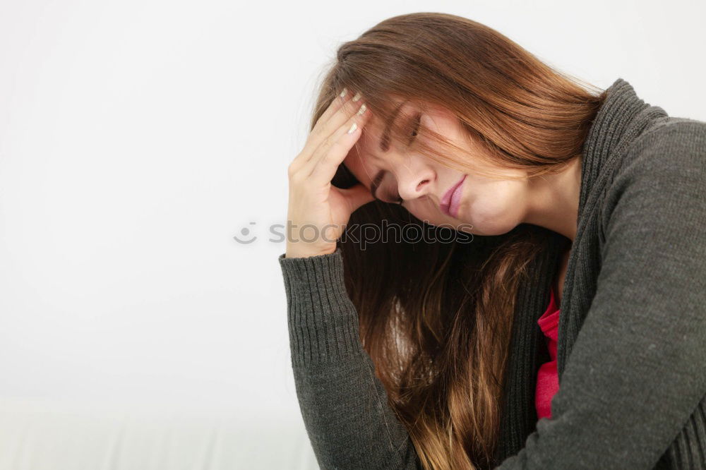 Similar – Image, Stock Photo one sad woman sitting near a wall and holding her head in her hands