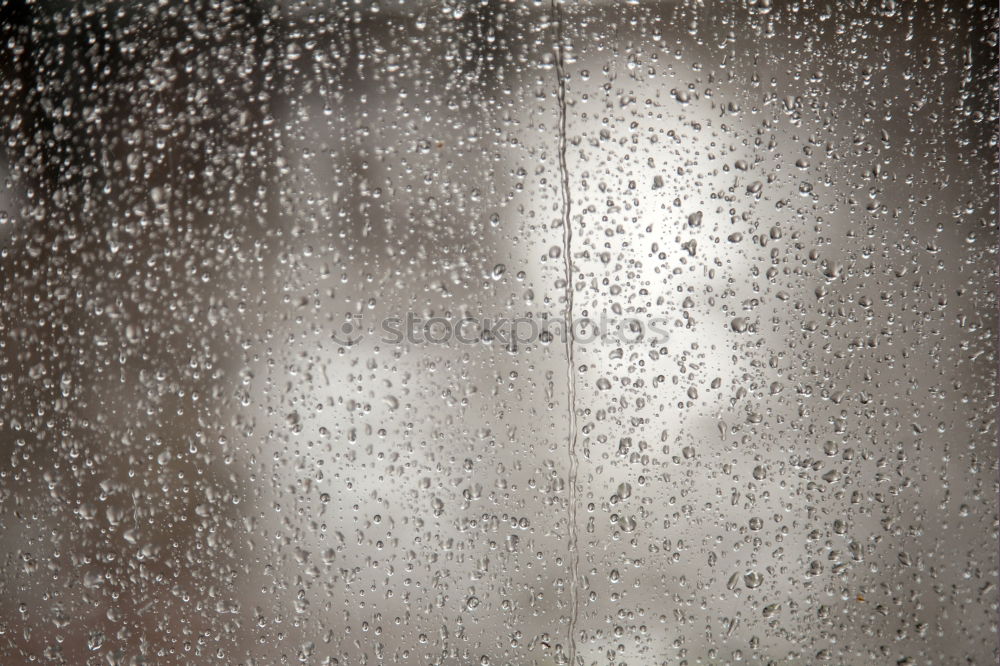 Blurred street through a rainy bus window in Hong Kong