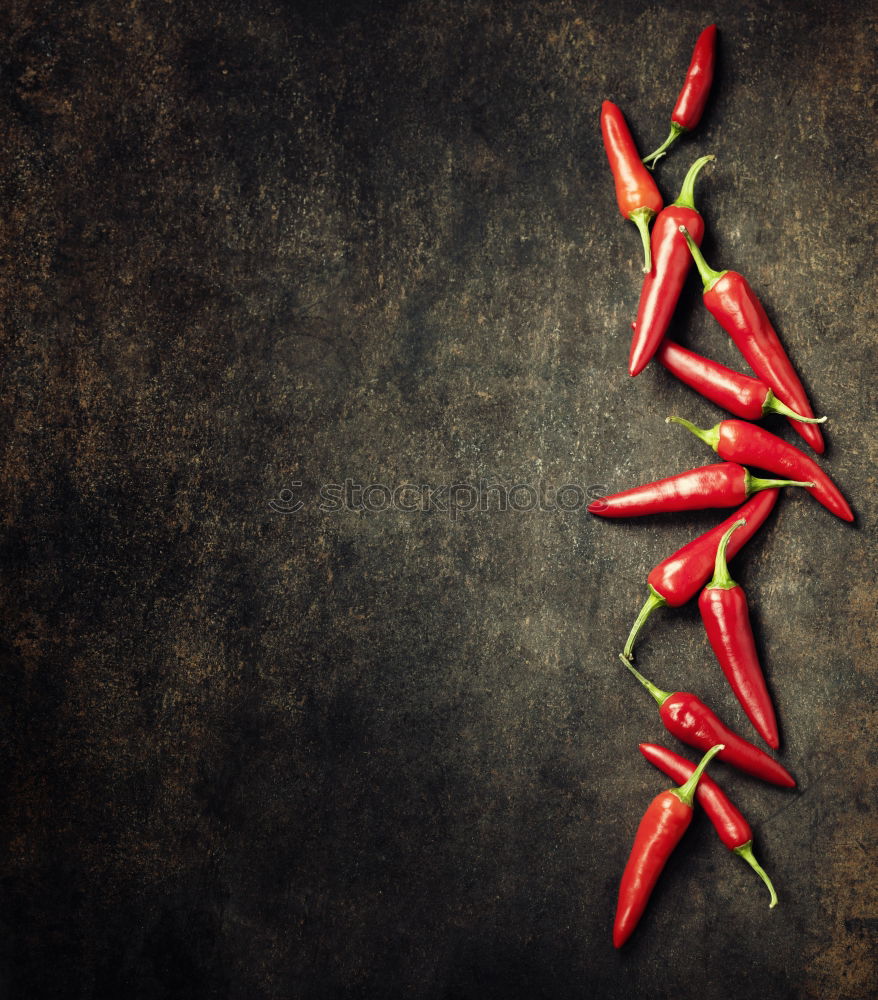 Rosemary, chopped chili and salt, wood background