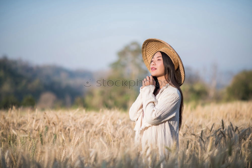 Similar – Woman in big round hat in middle of wheat field