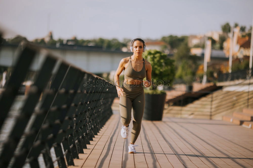 Similar – Young fitnesswoman runner stretching legs after run.