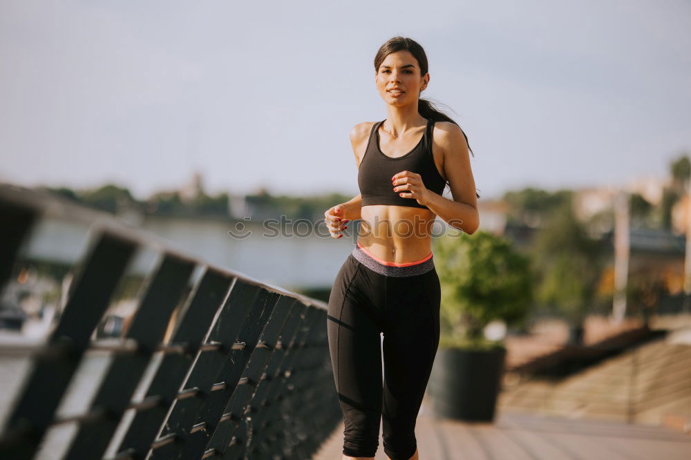 Similar – Young fitnesswoman runner stretching legs after run.