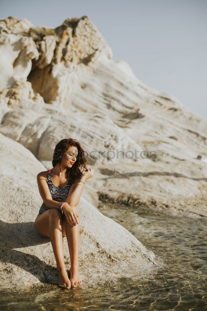 Similar – Beautiful young black woman sitting in a  wooden foot bridge at the beach