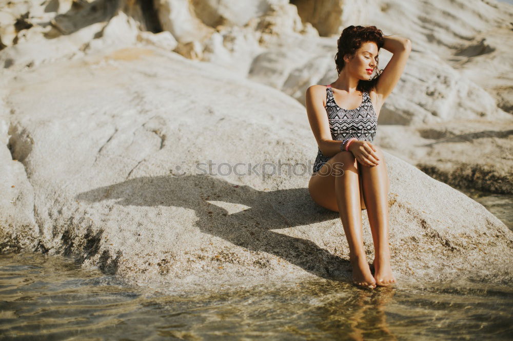 Similar – Happy girl posing on the stones of a river