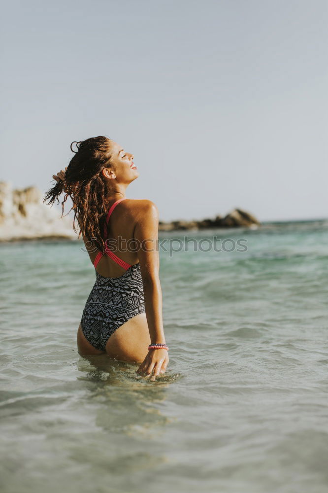 Similar – Back view of woman in bikini and long curly hair