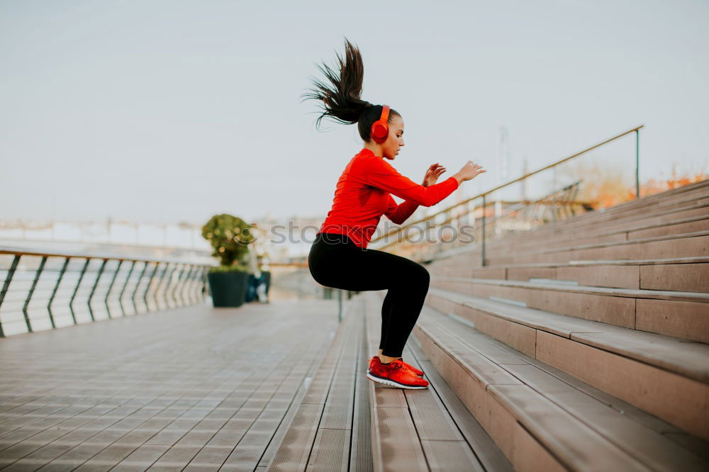 Similar – Young fitnesswoman runner stretching legs after run.