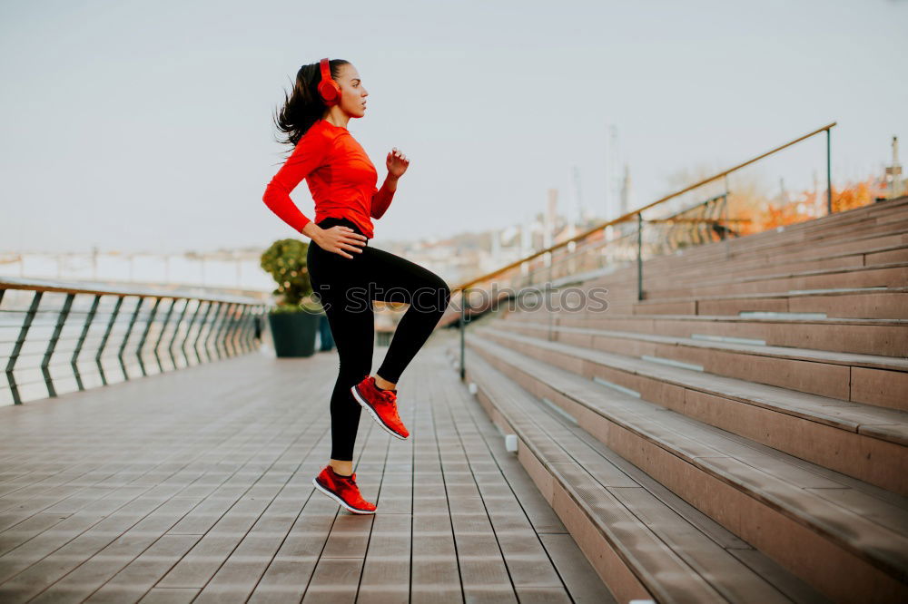 Similar – Young fitness woman runner running on city bridge.