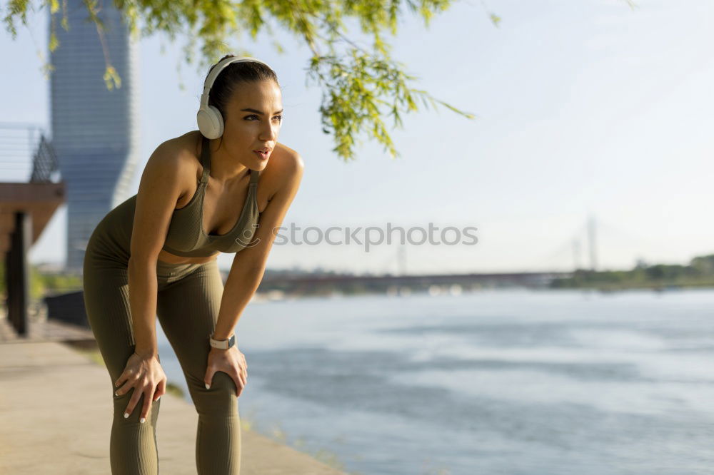 Similar – Young fitnesswoman runner stretching legs after run.