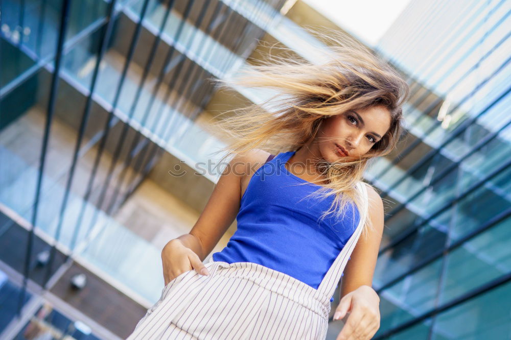 Similar – Beautiful young woman standing next to modern building.