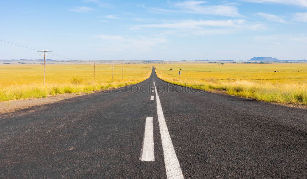 Similar – Fahrbahnmarkierungen eines amerikanischen Highways aus nächster Nähe an einem sonnigen Tag mit blauem Himmel.