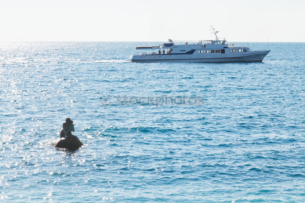 Similar – Man in wetsuit swimming in ocean