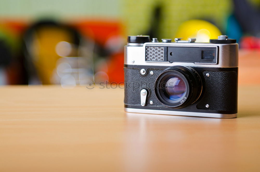 Similar – analogue 35mm camera on brown wooden table