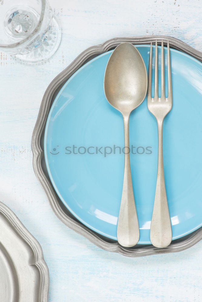 Similar – Disposable plastic cutlery on blue background. Top view