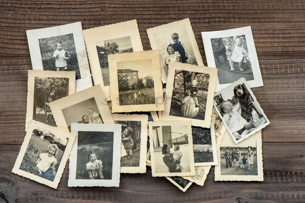 Photo album with old photos, child with doll, mother with child on her arm, both wearing hats