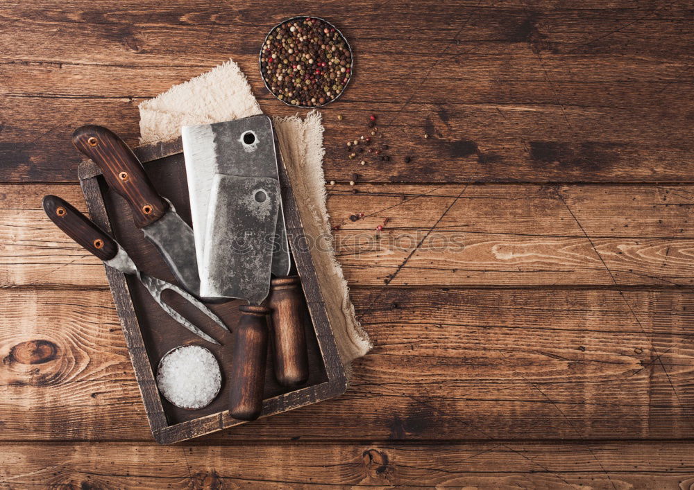 Similar – kitchen brown cutting board with handle and knife