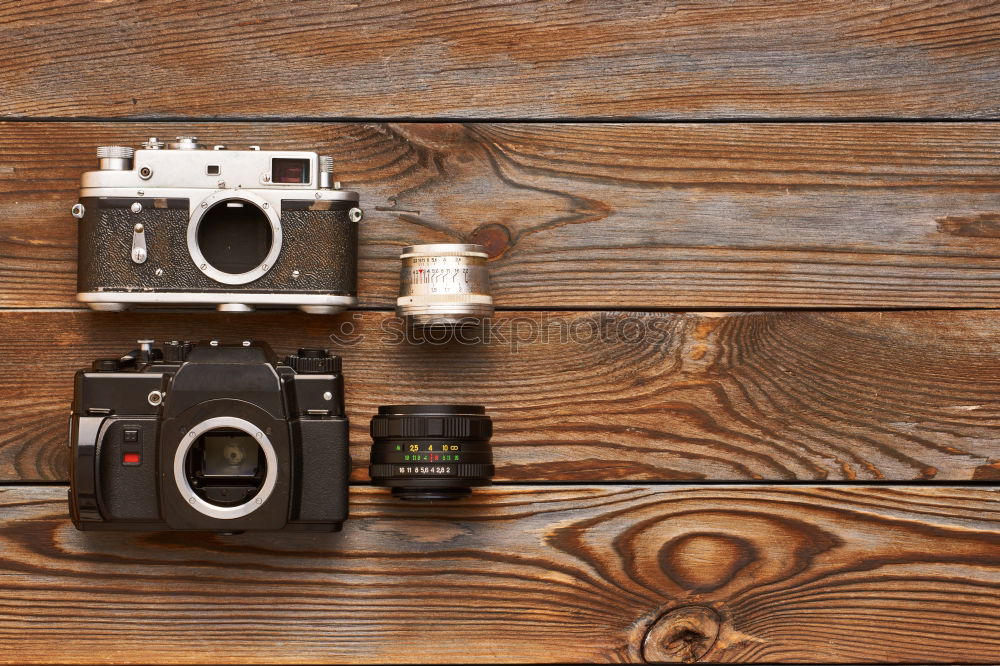 Similar – analogue 35mm camera on brown wooden table